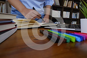 Young female in casual cloth studying in library