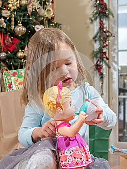 Young female caucasian girl opening presents