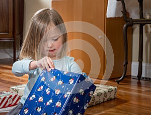 Young female caucasian girl opening presents