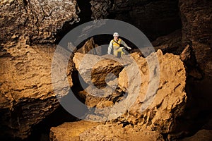 Young female caver exploring the cave