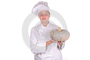 Young female chef showing a pumpkin