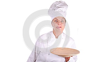 Young female chef showing a wooden dish