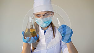 Young female chemist doing science experiment with chemicals