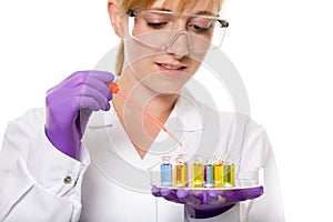 Young female chemist doing some research, isolated