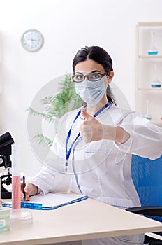 The young female chemist working in the lab