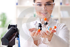 The young female chemist working in the lab