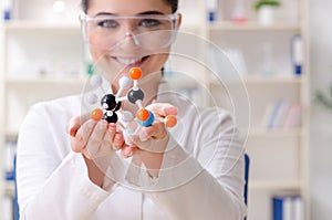 The young female chemist working in the lab