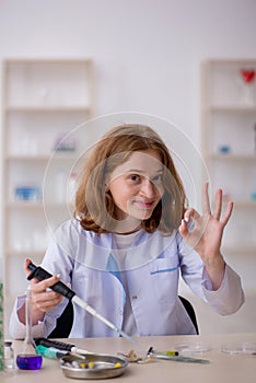 Young female chemist working at the lab