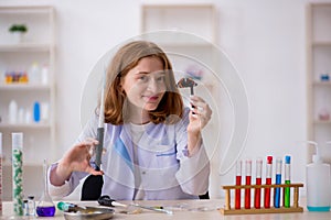 Young female chemist working at the lab