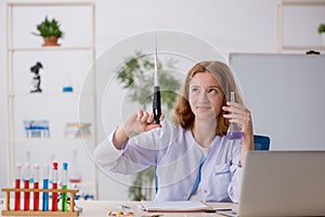 Young female chemist working at the lab