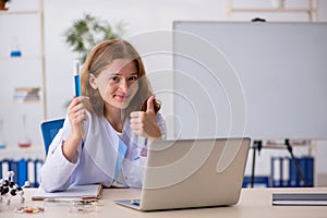 Young female chemist working at the lab