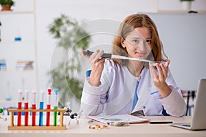 Young female chemist working at the lab