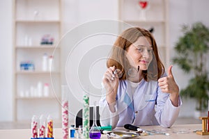 Young female chemist working at the lab