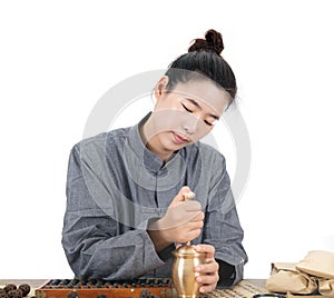 A young female Chinese medicine doctor mashed the herbs using a medicine mortar