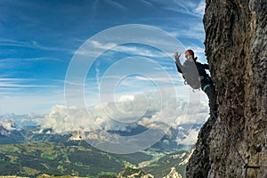 Young female climber on a vertical and exposed rock wall