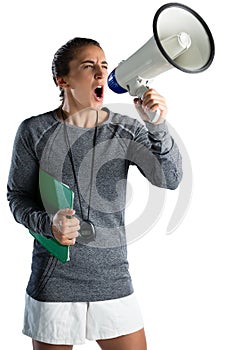 Young female coach announcing on megaphone