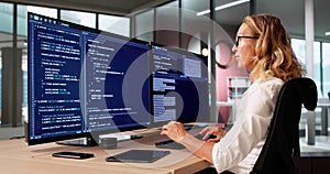 Young Female Coder Writing Code On Computer Screen