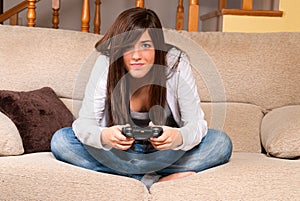 Young female concentrating playing videogames photo