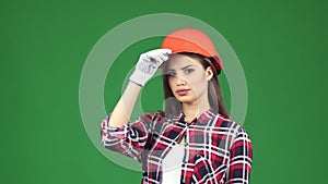 young female contractor wearing hardhat showing thumbs up