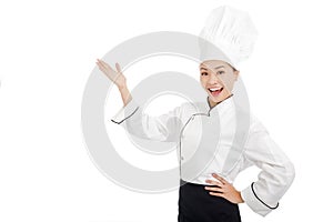 Young female cook raise hands to show something