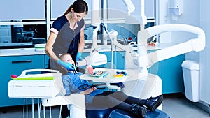 Young female dentist working in her office.