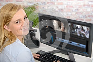 Young female designer using computer for video editing