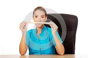 Young female dietician holding measure tape