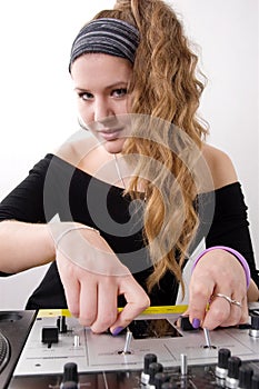 Young female dj playing