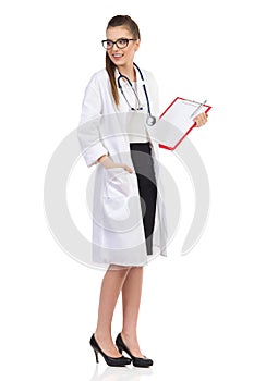 Young Female Doctor With Clipboard Looking Over Shoulder