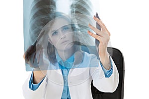 Young female doctor examining an x-ray image