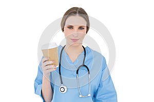 Young female doctor holding a coffee mug