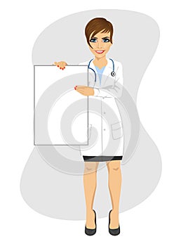 Young female doctor holding empty blank board