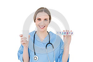 Young female doctor holding a plastic cup and medicine