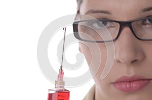 Young female doctor holding a syringe