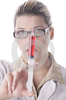 Young female doctor holding a syringe