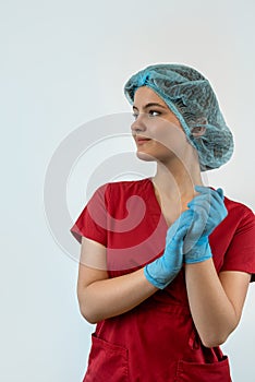 Young female doctor in labcoat looking at camera isolated