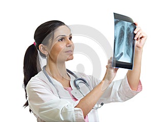 Young female doctor looking at the x-ray shot of lungs. Isolated on white.