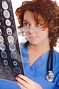 Young female doctor looking at tomogram