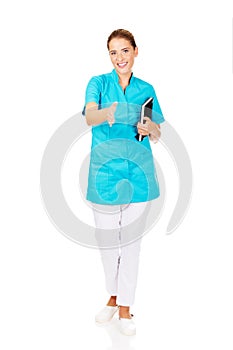 Young female doctor or nurse holding black notes