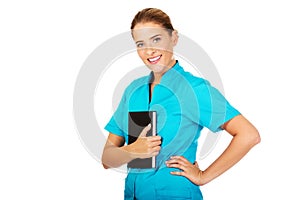 Young female doctor or nurse holding black notes