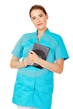 Young female doctor or nurse holding black notes