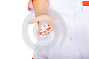 Young female doctor or nurse holding pink breast cancer awareness ribbon