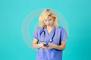 Young female doctor or nurse wearing blue scrub uniform