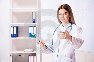 The young female doctor standing in front of the white board