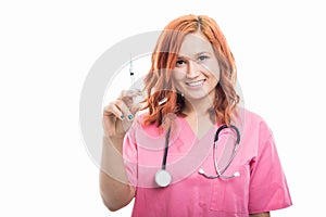 Young female doctor with stethoscope holding diabetes syringe