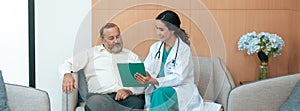 Young female doctor in white medical gown showing medical test result explaining prescription using clipboard senior man patient