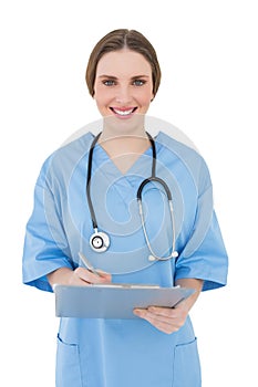 Young female doctor working with her clipboard