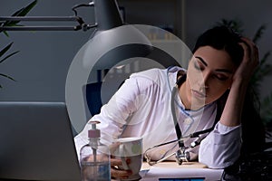 The young female doctor working at night shift