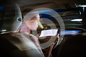 Young female driver playing with her cellphone instead of paying attention to driving