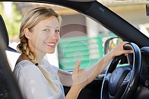 young female driver showing thumbs up